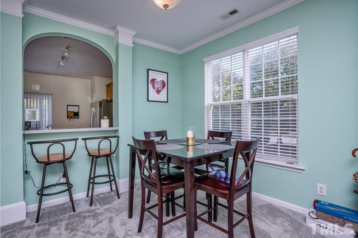 7604 Canvas Art Terrace Raleigh, NC 27617 - Photo 6 of 20 a view of a dining room with furniture and a window