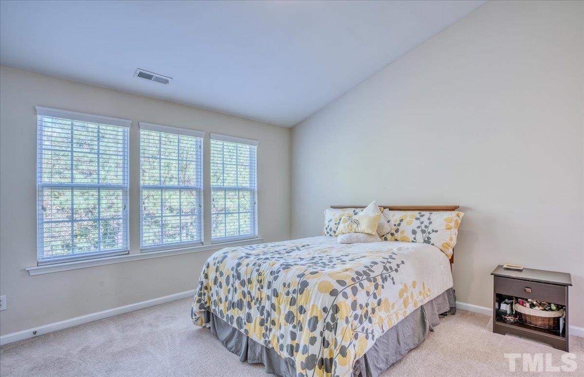 7604 Canvas Art Terrace Raleigh, NC 27617 - Photo 8 of 20 a bedroom with a bed and a large window