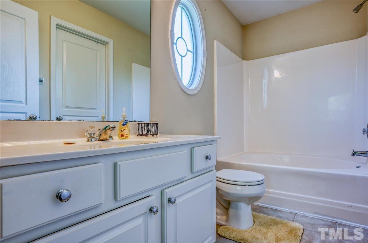 7604 Canvas Art Terrace Raleigh, NC 27617 - Photo 10 of 20 a bathroom with a sink and a mirror