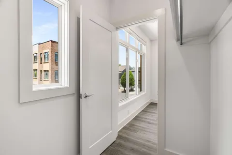 a view of a hallway with windows and entryway