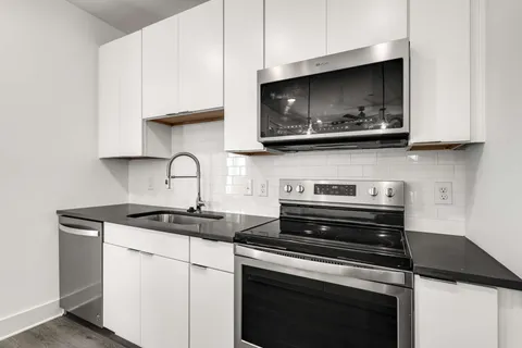 a kitchen with a stove and a microwave