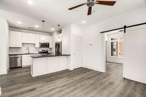 a kitchen with stainless steel appliances a refrigerator and a stove top oven