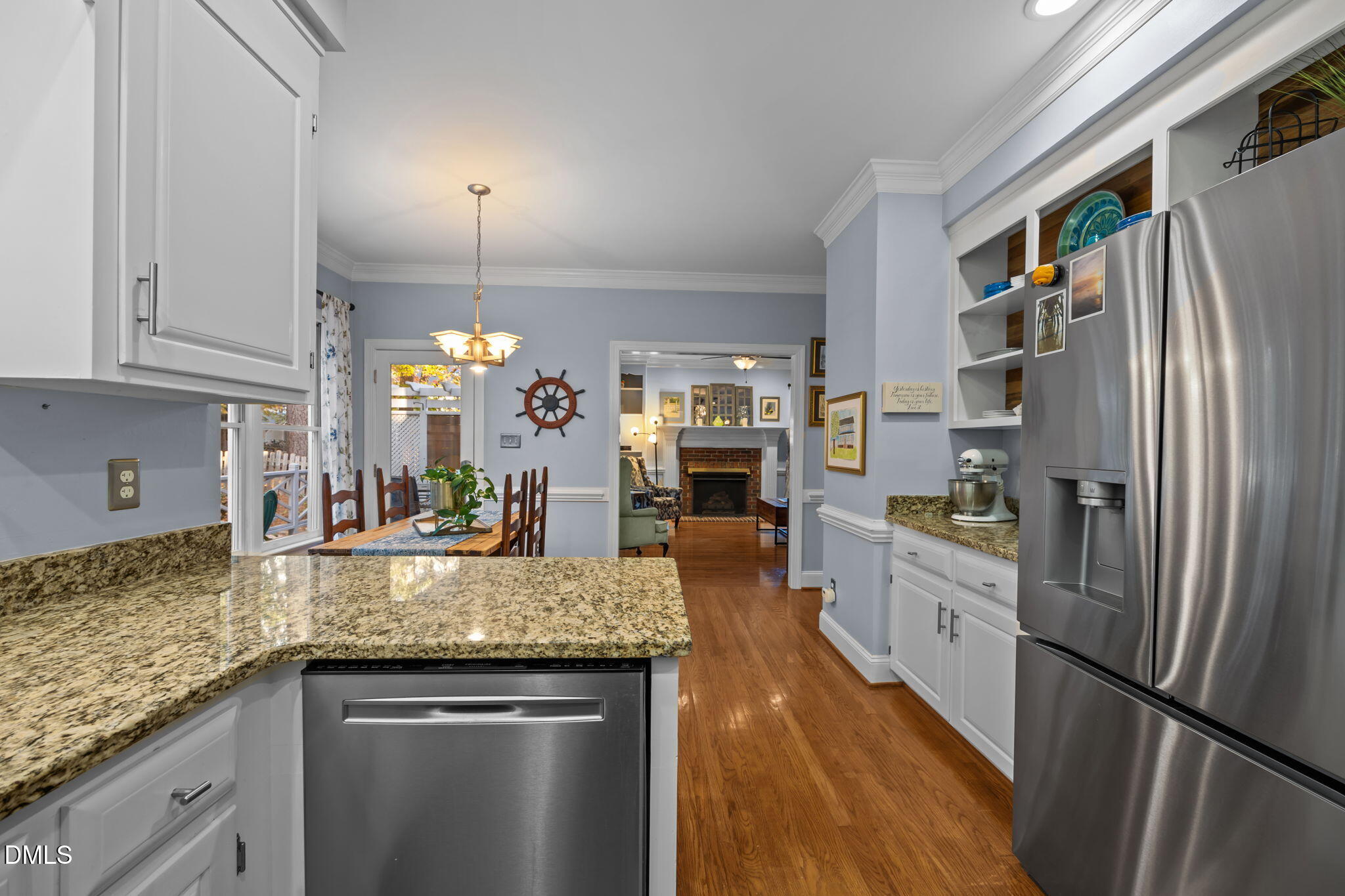 4304 Omni Place Raleigh, NC 27613 - Photo 20 of 58 a kitchen with granite countertop kitchen island stainless steel appliances a refrigerator a sink a stove cabinets and living room view
