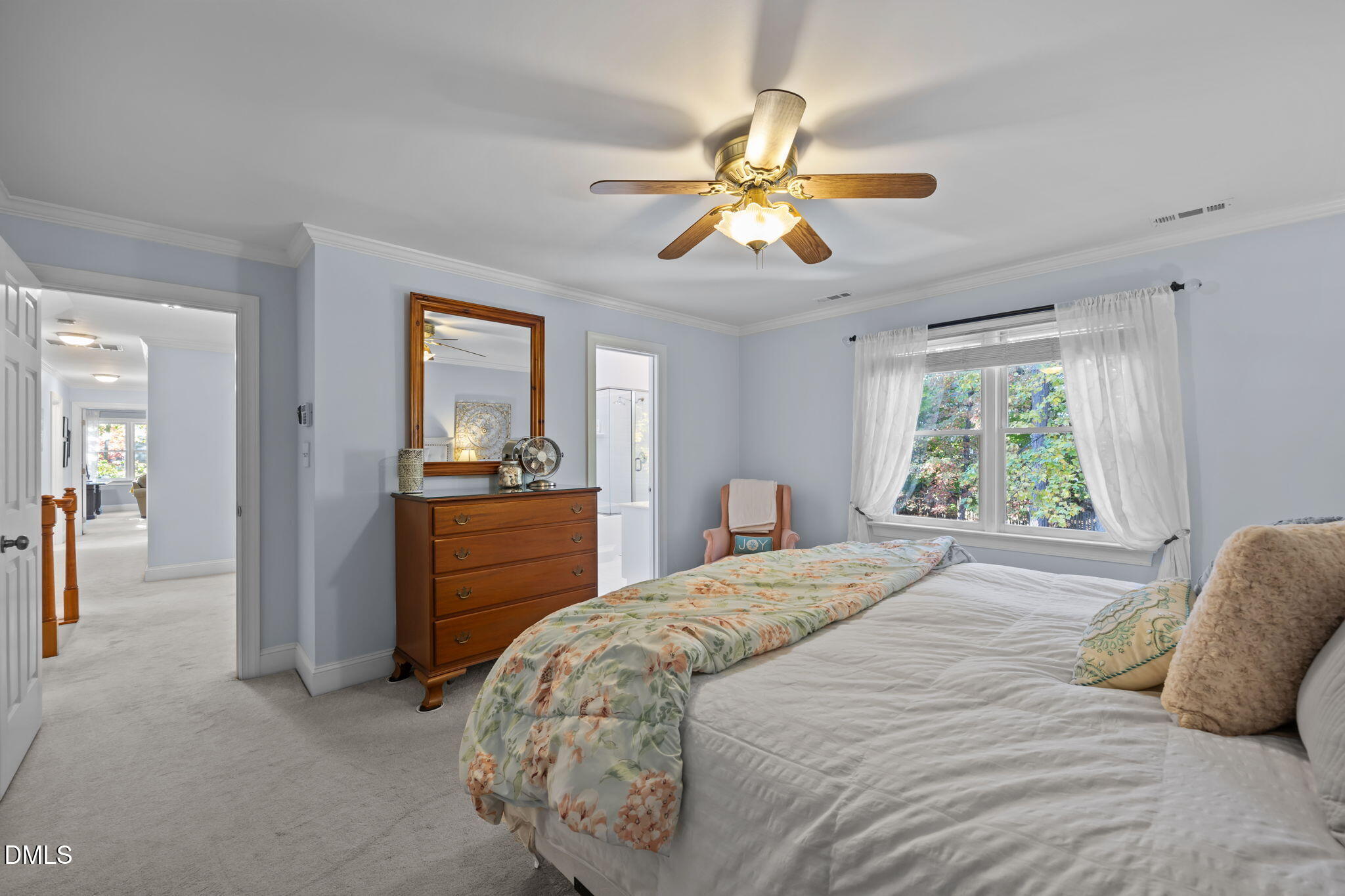 4304 Omni Place Raleigh, NC 27613 - Photo 27 of 58 a bedroom with a bed and a chandelier