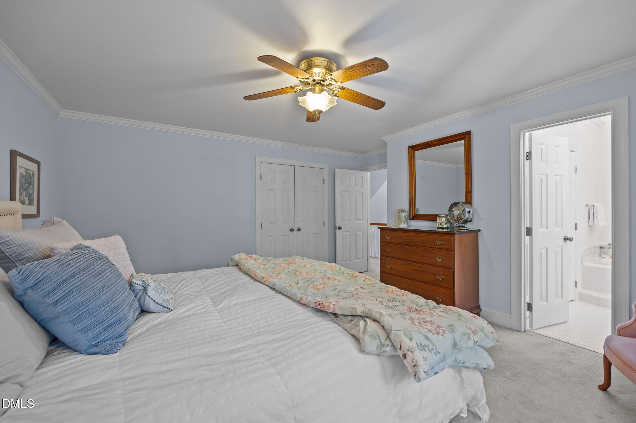 4304 Omni Place Raleigh, NC 27613 - Photo 28 of 58 a bedroom with a bed and a chandelier