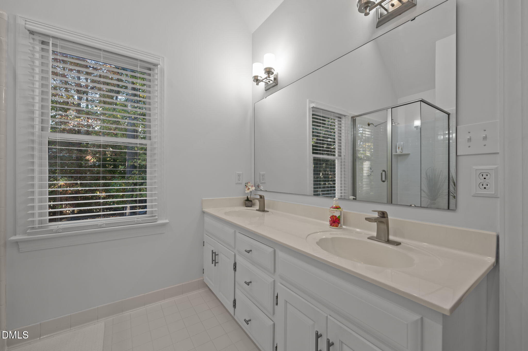 4304 Omni Place Raleigh, NC 27613 - Photo 31 of 58 a bathroom with double vanity and a mirror