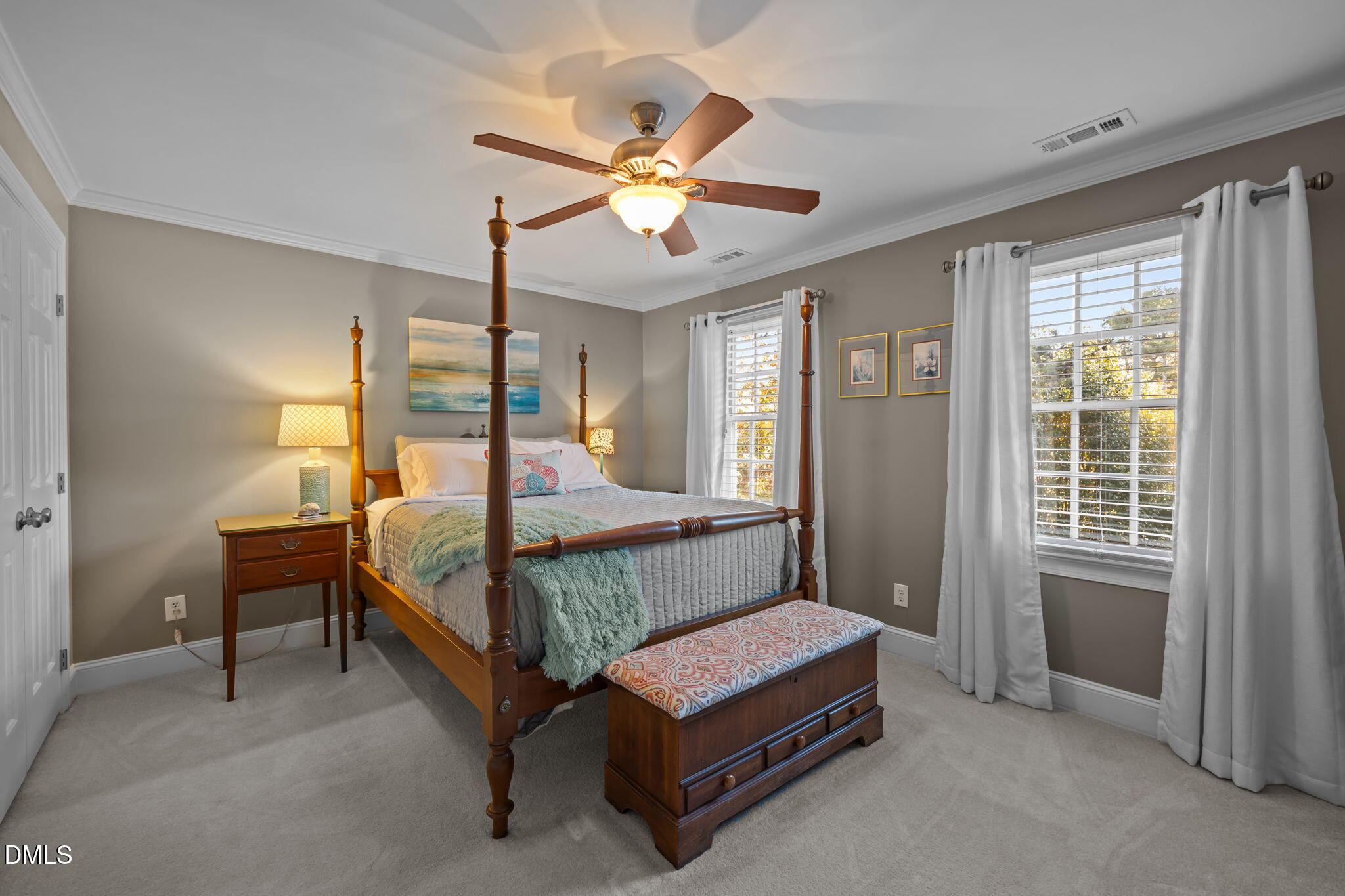 4304 Omni Place Raleigh, NC 27613 - Photo 33 of 58 a bedroom with a bed and a chandelier