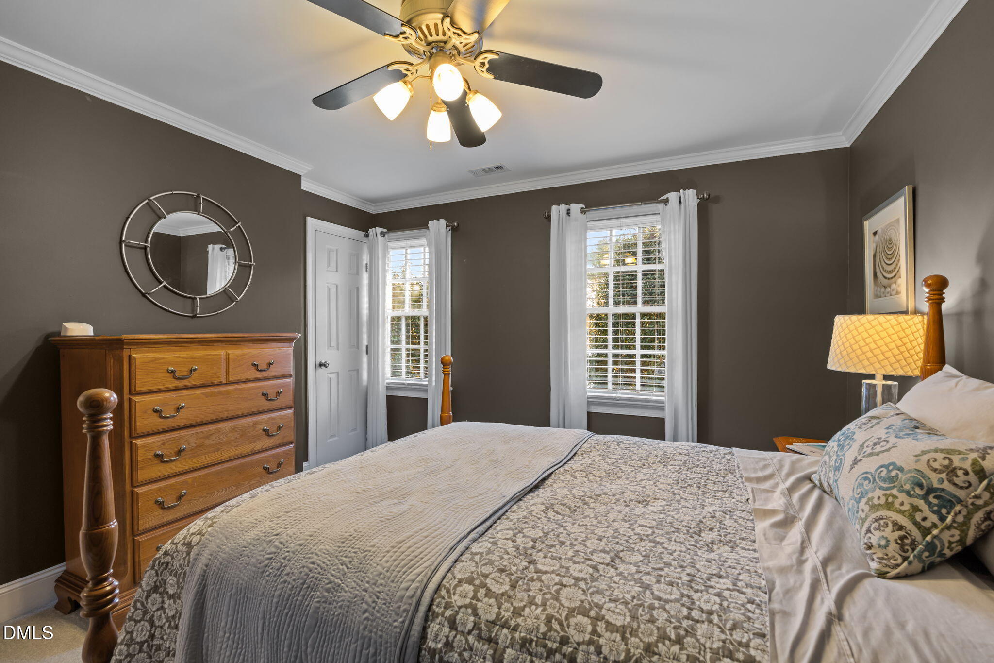 4304 Omni Place Raleigh, NC 27613 - Photo 35 of 58 a bedroom with a bed and a chandelier