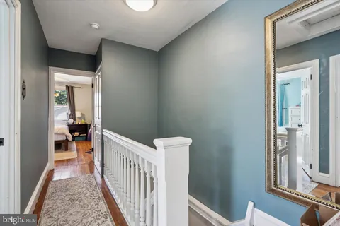 a view of a hallway with a livingroom and furniture