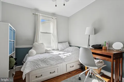 a bedroom with a bed and a table in it