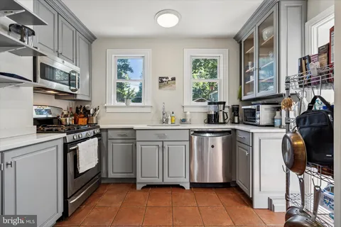 a kitchen with stainless steel appliances granite countertop a sink and cabinets