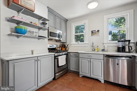 a kitchen with stainless steel appliances granite countertop a sink and cabinets