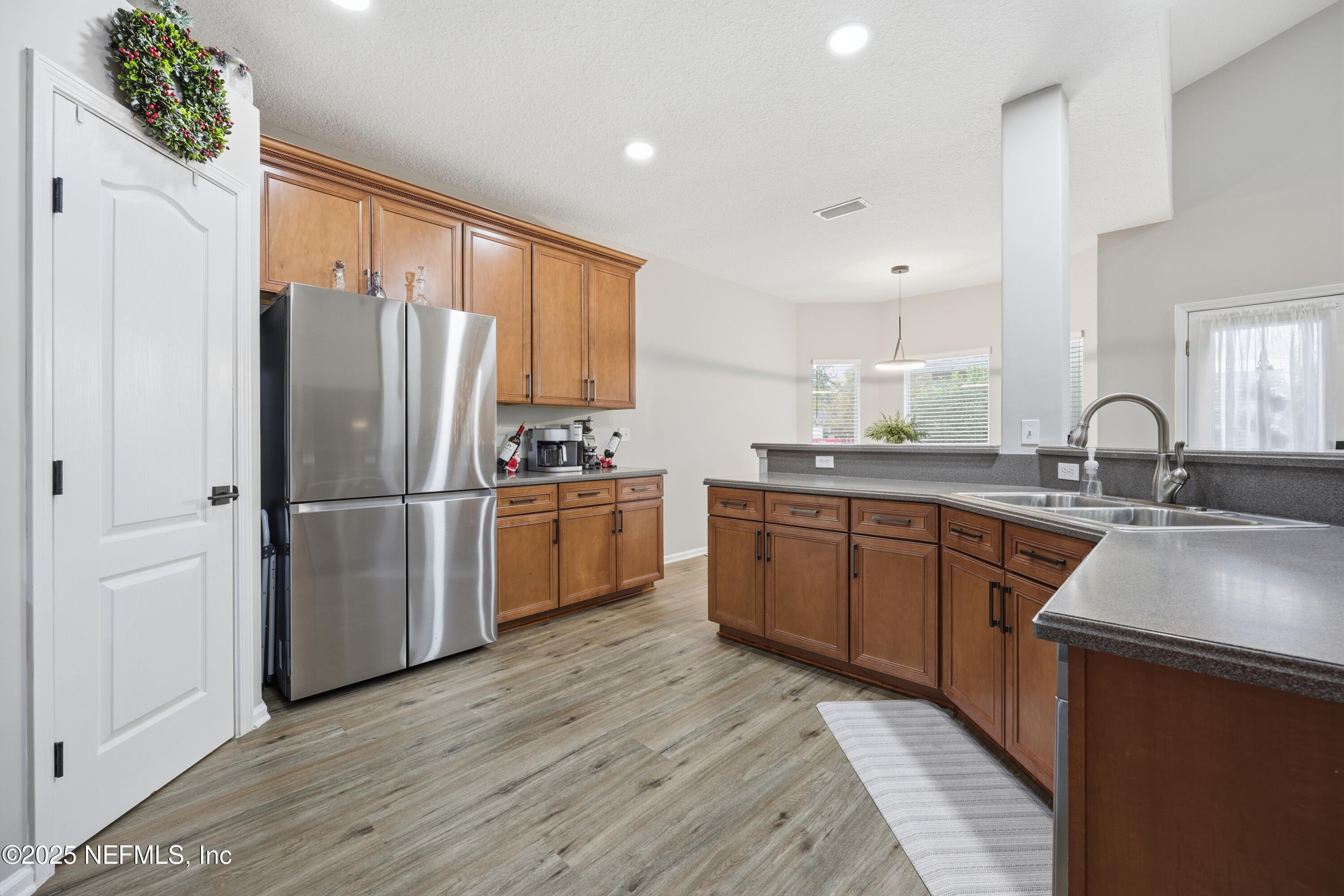 2301 Country Side Drive Fleming Island, FL 32003 - Photo 20 of 58 a kitchen with refrigerator cabinets and wooden floor