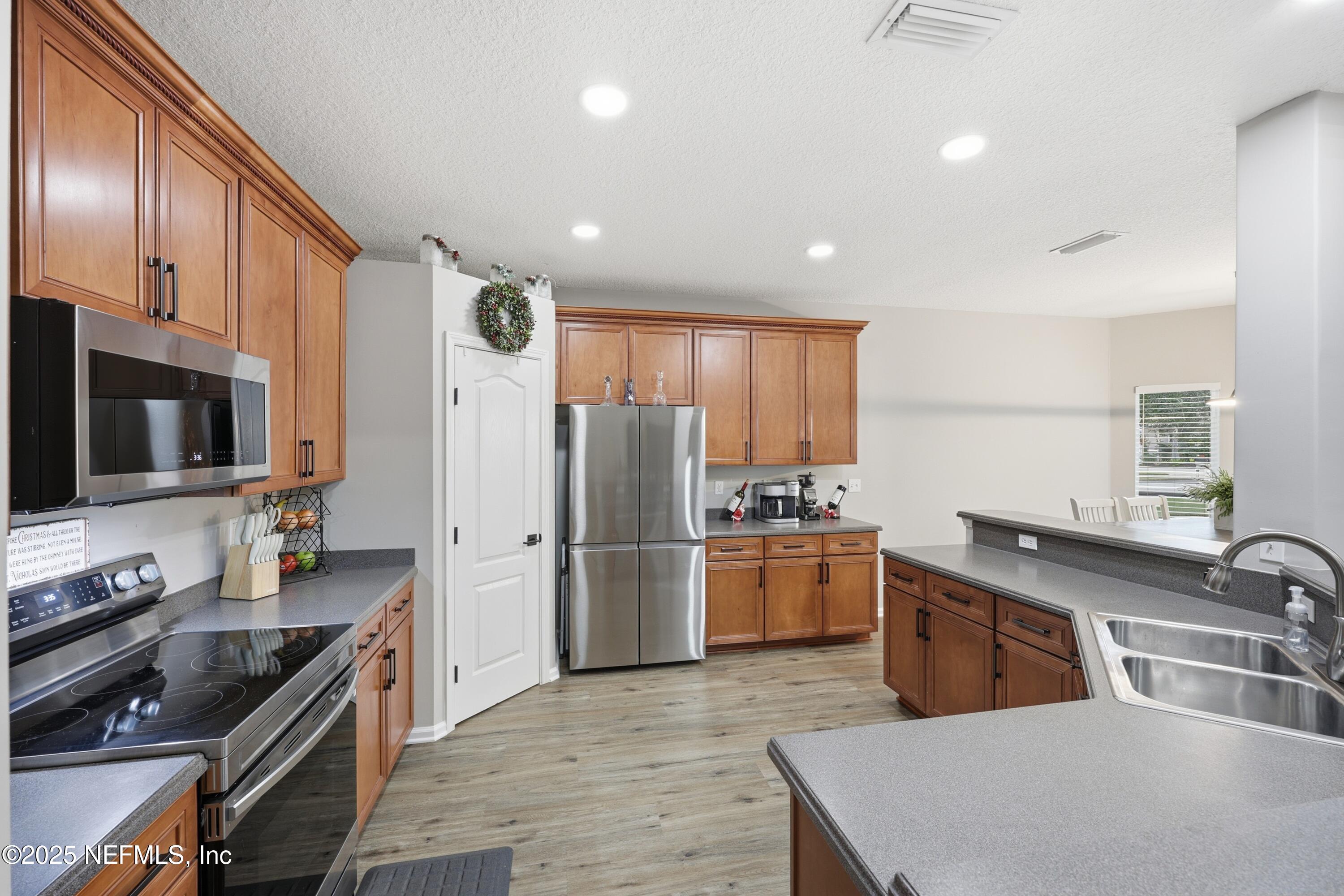 2301 Country Side Drive Fleming Island, FL 32003 - Photo 22 of 58 a kitchen with refrigerator cabinets and furniture