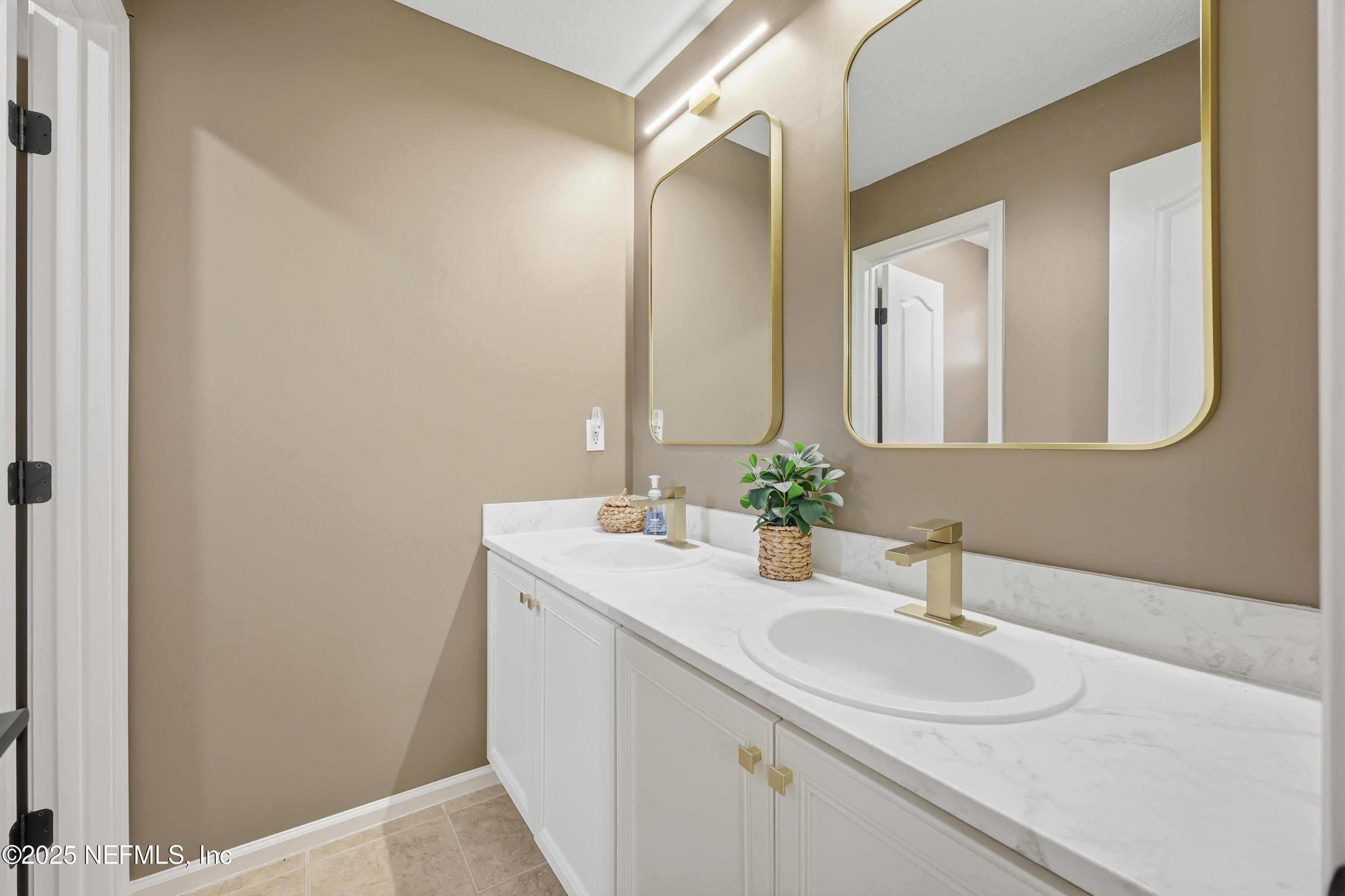 2301 Country Side Drive Fleming Island, FL 32003 - Photo 30 of 58 a bathroom with a sink and a mirror