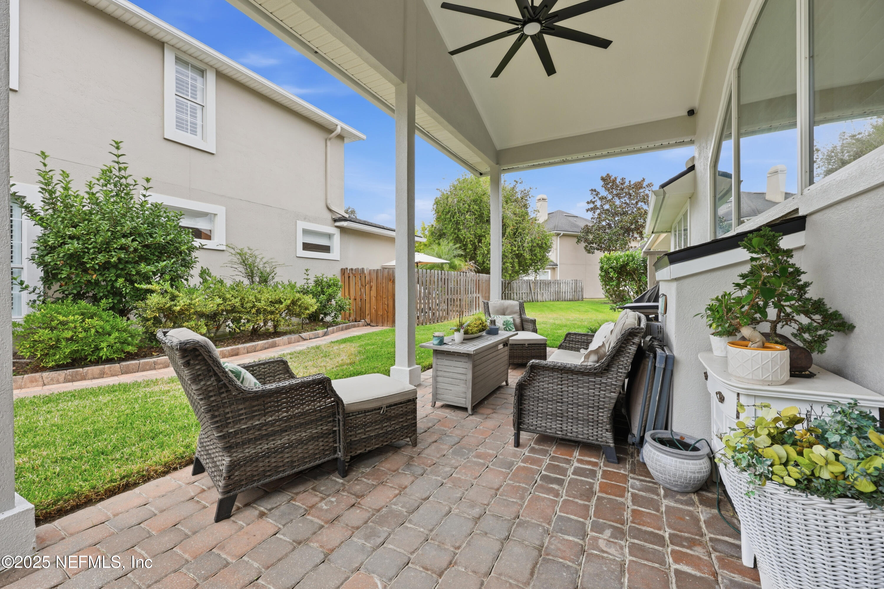 2301 Country Side Drive Fleming Island, FL 32003 - Photo 35 of 58 a view of a patio with a table and chairs and potted plants