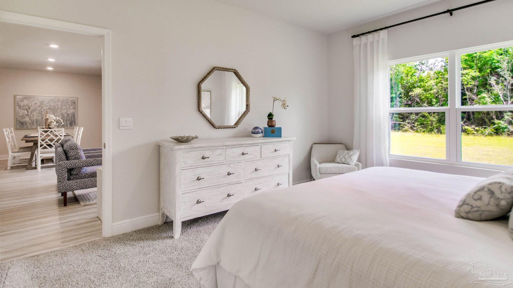 132 Albatross Street Cantonment, FL 32533 - Photo 18 of 35 a bedroom with a bed and a mirror