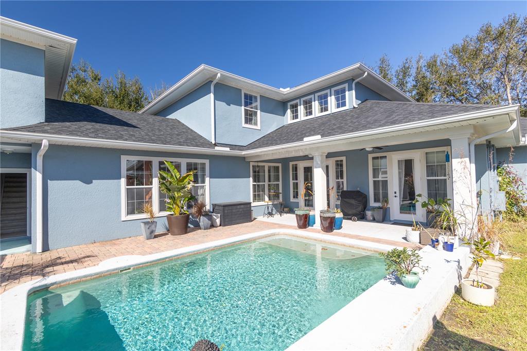 3305 Schoolhouse Road St. Cloud, FL 34773 - Photo 4 of 83 a view of a house with a yard patio and fire pit