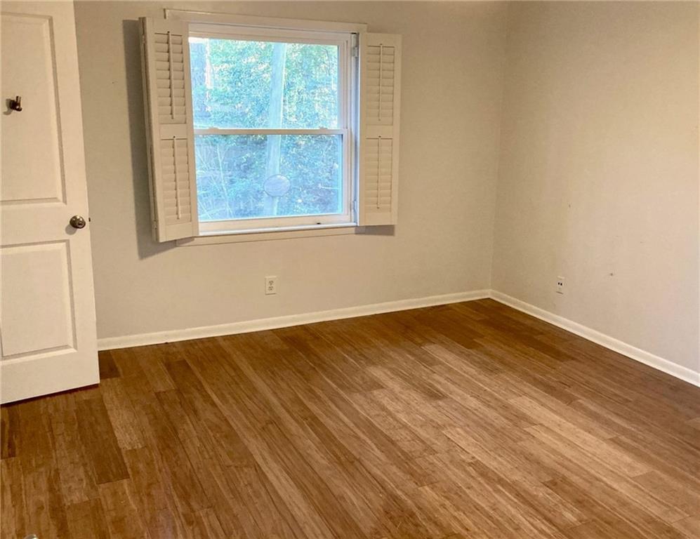 1010 Scott Boulevard, Unit E4 Decatur, GA 30030 - Photo 6 of 16 an empty room with wooden floor and windows