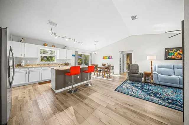 a living room with furniture and kitchen view