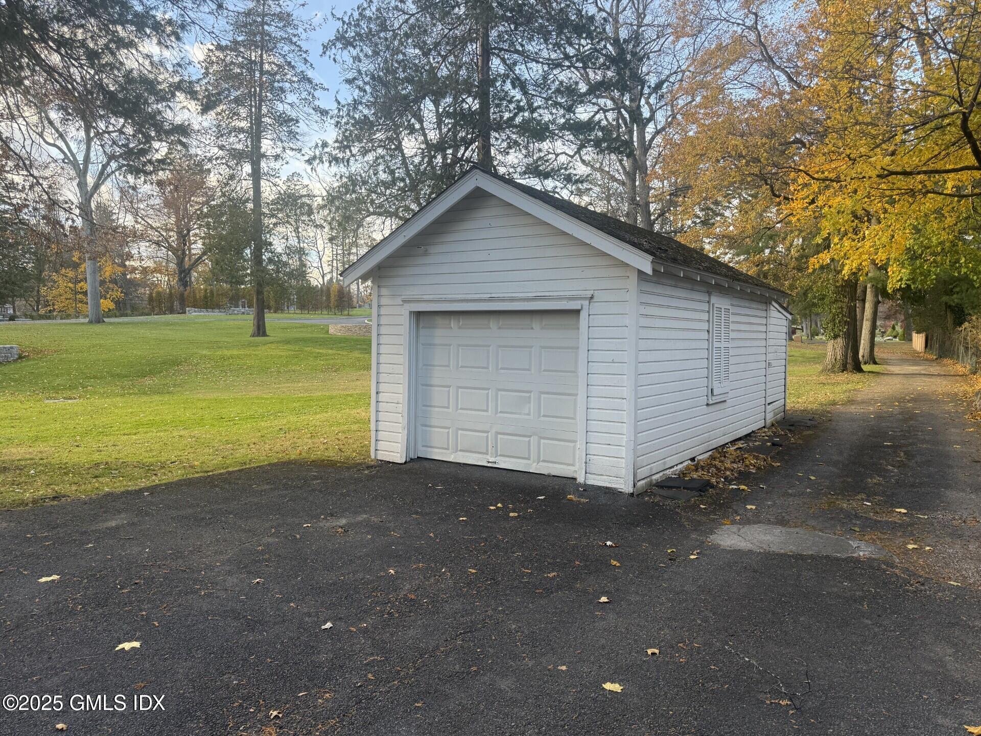33 Parsonage Road Greenwich, CT 06830 - Photo 3 of 14 a view of a house with a yard and garage