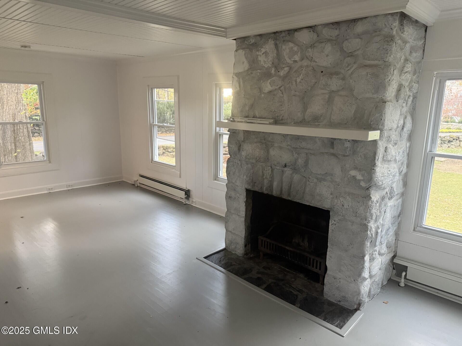 33 Parsonage Road Greenwich, CT 06830 - Photo 4 of 14 a living room with a fireplace windows and a ceiling fan