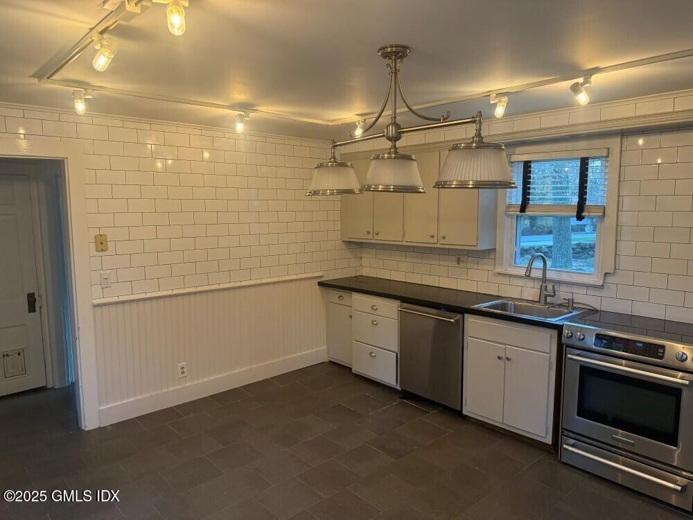 33 Parsonage Road Greenwich, CT 06830 - Photo 5 of 14 a kitchen with a sink stainless steel appliances and cabinets