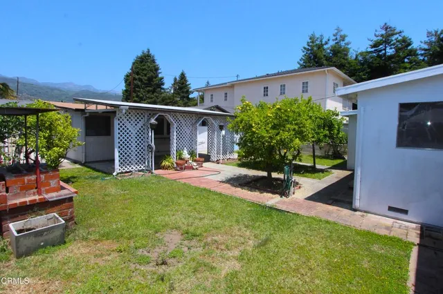 a view of a backyard with plants and a patio