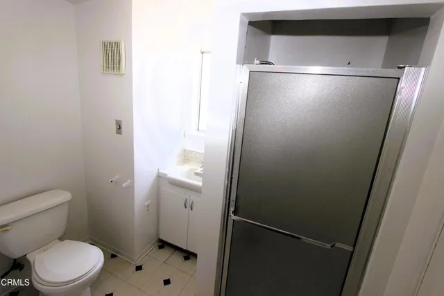 a bathroom with a toilet and a shower