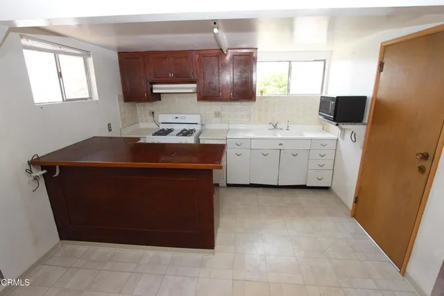 a utility room with cabinets washer and dryer