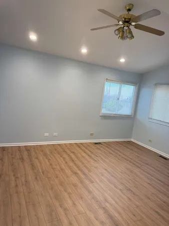 an empty room with a empty space and chandelier fan
