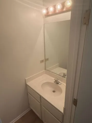 a bathroom with a sink and vanity