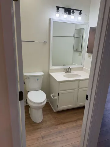 a bathroom with a toilet sink and mirror