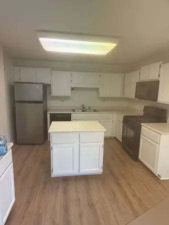 a utility room with sink dryer and washer