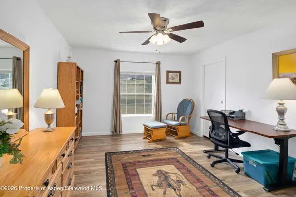 a work room with furniture and wooden floor