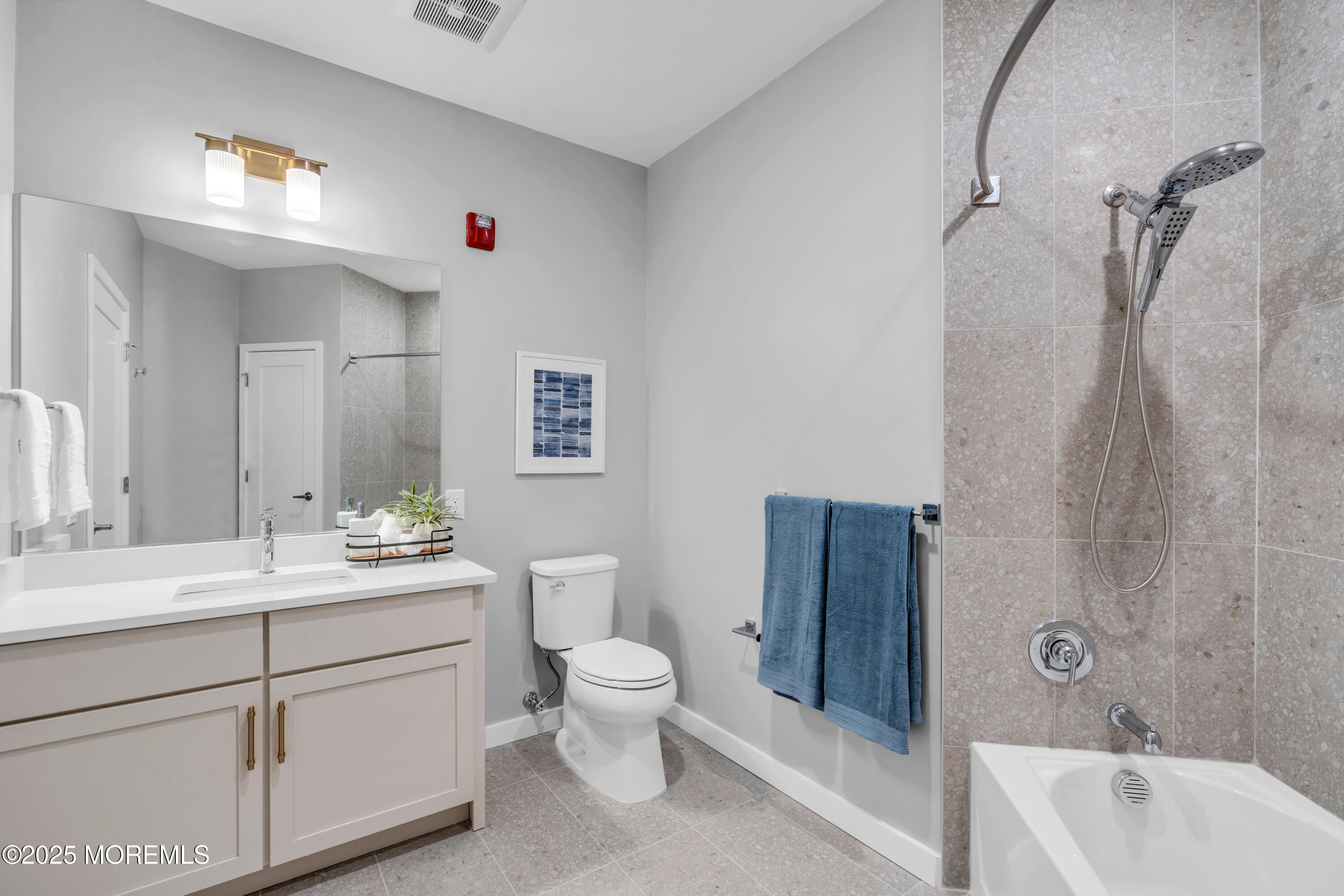 120 Monmouth Street, Unit RIVERS EDGE 307 Red Bank, NJ 07701 - Photo 15 of 38 a bathroom with a double vanity sink toilet mirror and bathtub