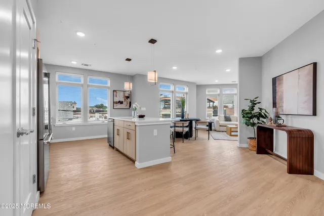 a kitchen with furniture and a large window