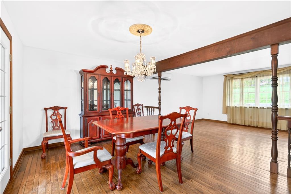 709 Vernon Drive Rostraver Township, PA 15012 - Photo 11 of 40 a view of a dining room with furniture wooden floor and chandelier