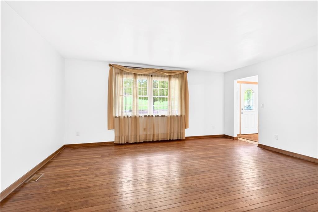 709 Vernon Drive Rostraver Township, PA 15012 - Photo 14 of 40 an empty room with wooden floor and windows