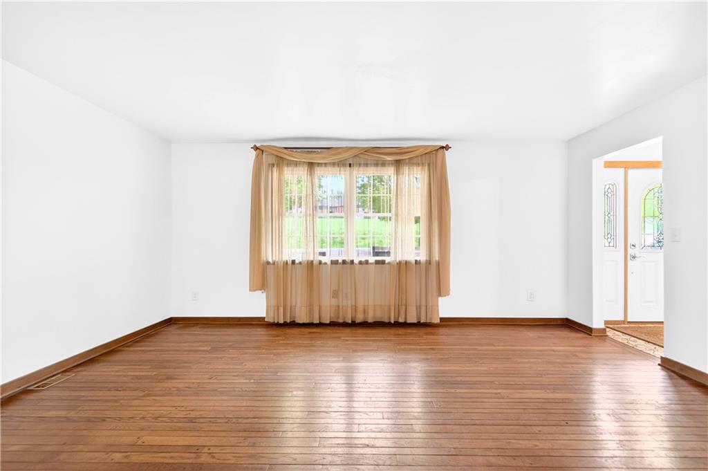 709 Vernon Drive Rostraver Township, PA 15012 - Photo 15 of 40 an empty room with wooden floor and windows