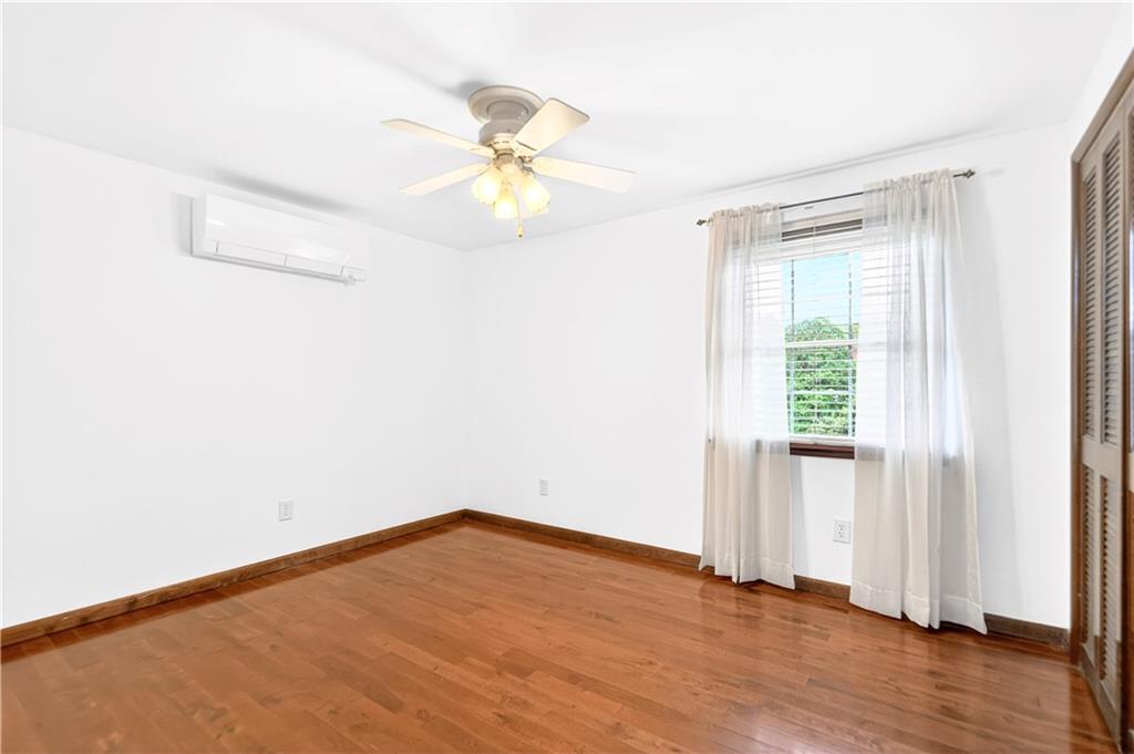 709 Vernon Drive Rostraver Township, PA 15012 - Photo 20 of 40 an empty room with wooden floor fan and windows