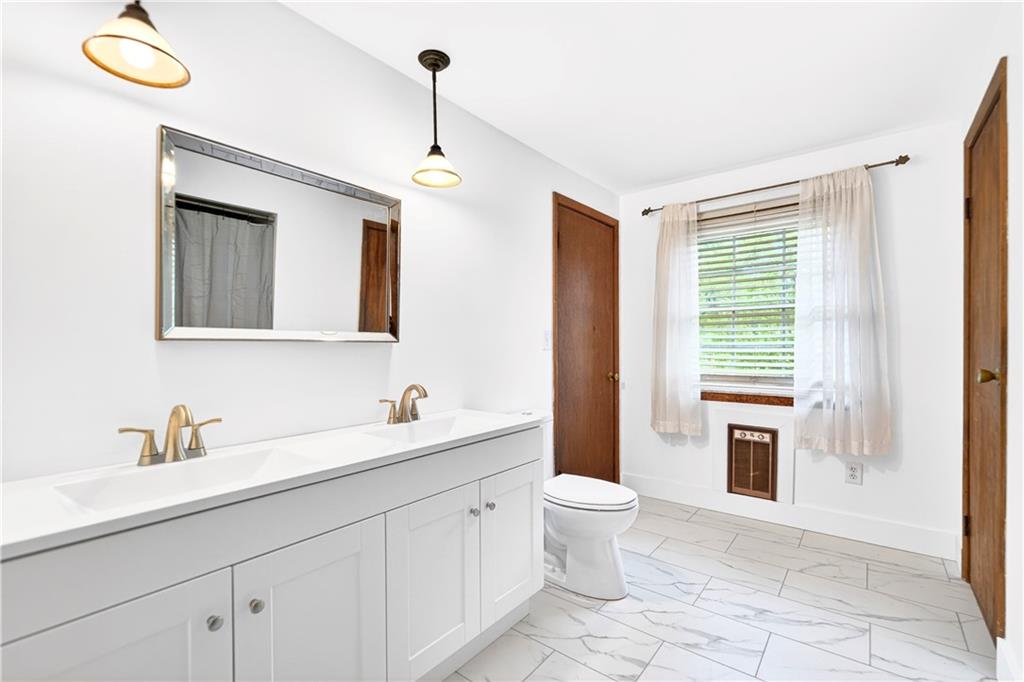 709 Vernon Drive Rostraver Township, PA 15012 - Photo 40 of 40 a bathroom with a toilet sink and mirror
