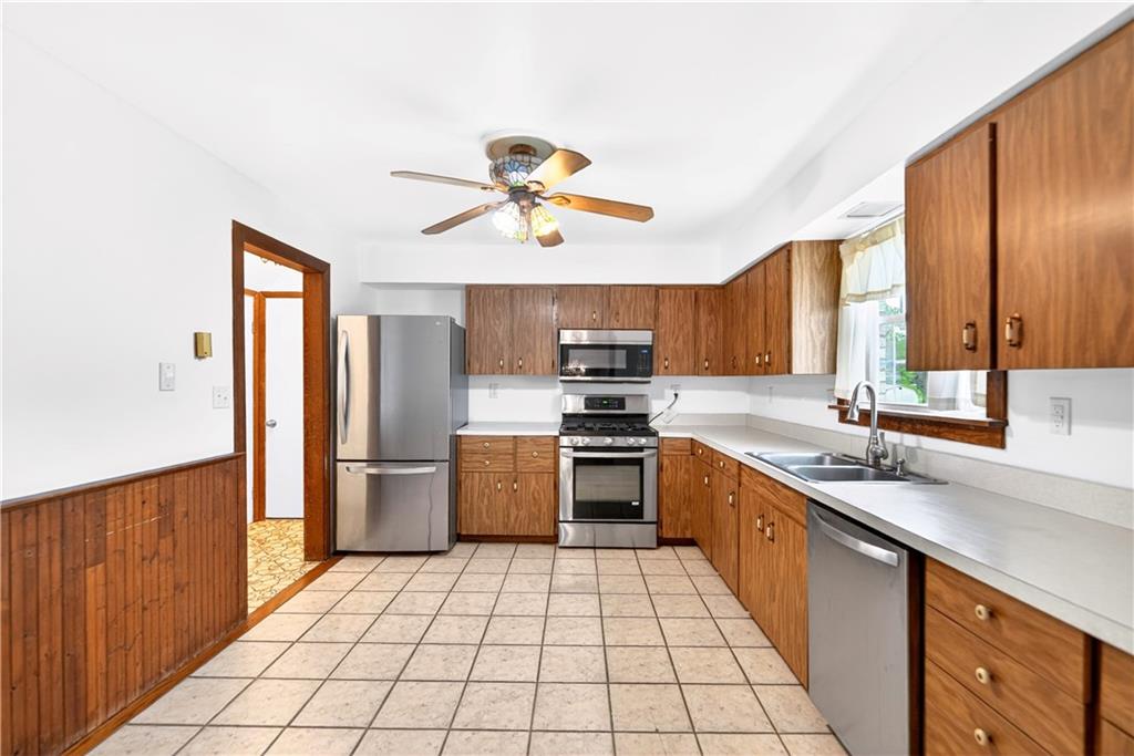 709 Vernon Drive Rostraver Township, PA 15012 - Photo 7 of 40 a kitchen with stainless steel appliances a sink cabinets and window