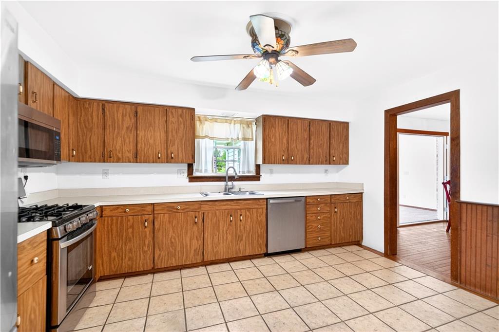 709 Vernon Drive Rostraver Township, PA 15012 - Photo 9 of 40 a kitchen with stainless steel appliances granite countertop a stove a sink and a refrigerator