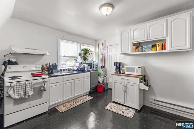 a kitchen with a sink cabinets and window