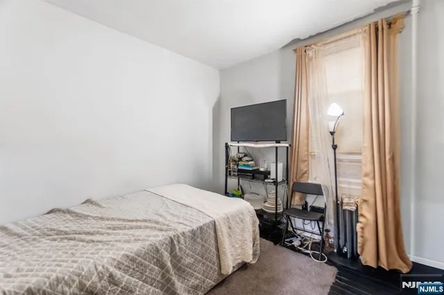 a bedroom with a bed and a mirror