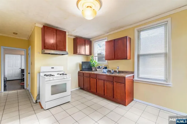 a kitchen with stainless steel appliances granite countertop a stove and a sink