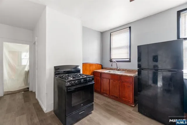 a kitchen with stainless steel appliances granite countertop a stove a refrigerator and a stove