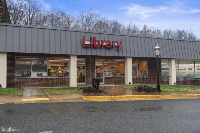 a view of a house with swimming pool and sitting area