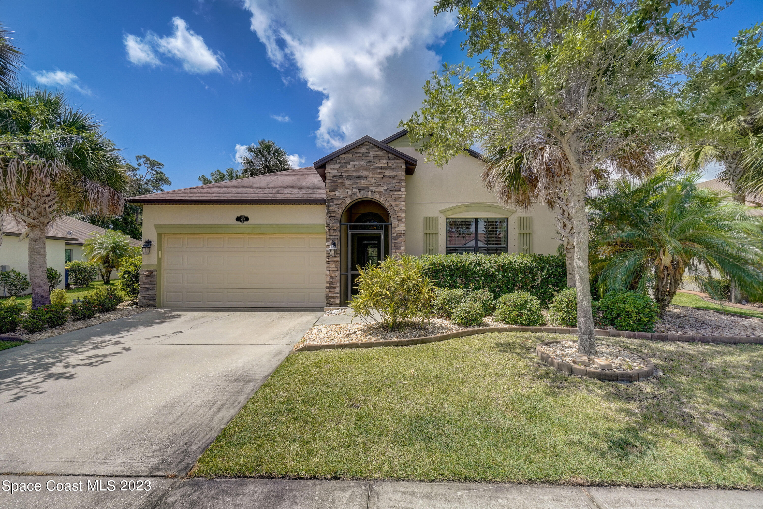 1568 Outrigger Circle Rockledge, FL 32955 - Photo 1 of 44 a front view of a house with garden